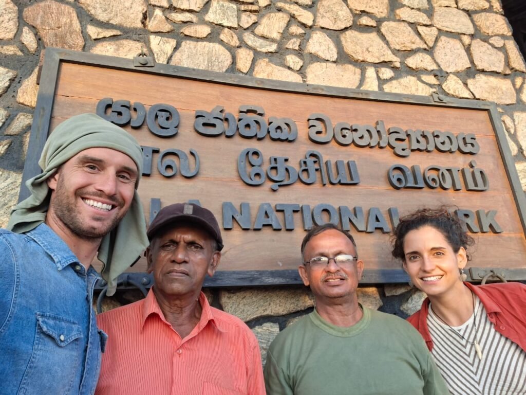 Guests and local guides in front of Yala National Park sign